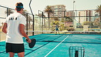 Back, coach and man with sports on court for challenge, padel lesson and wellness. People, instructor and help with tennis game for practice outdoor, skills performance and advice of personal trainer