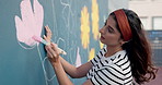 Art, woman and painting mural outdoor for creative design, decoration and volunteer with friends. Artist, girl and painter in city with brush for community wall, floral color and charity project
