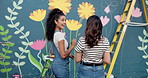 Wall art, women and painting mural with teamwork for creative, community project and student hobby. Friends, people and ladder for flowers artist, diy decor and painter with expression outdoors