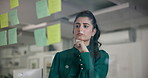 Business woman, thinking or planning with sticky notes for brainstorming on glass board at office. Female person, employee or thoughtful planner in wonder with schedule for project ideas at workplace