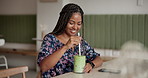 Happy woman, green drink and cafe with diet for healthy beverage, smoothie or detox at restaurant. African shopper, female person or smile in joy with organic cocktail or mocktail at coffee shop