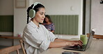 Woman, headphones and typing on laptop at coffee shop for research, email feedback and streaming podcast. Person, online web and information for writing article, listening to music and editing story