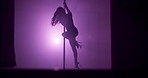 Woman, stage and pole in silhouette for dance, exotic performance or spinning in spotlight. Purple neon, aesthetic or performer in shadow with burlesque dancer, bright light or space in private venue