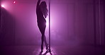 Woman, exotic dancing and pole for show, stage and creativity with balance for concert event in dark. Person, dancer and movement with high heels, performance and flexible for fantasy at nightclub