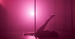 Woman, dancing and pole with legs, flexible and creativity with balance for concert event in dark. Person, exotic dancer and movement on stage, performance or talent on floor for fantasy at nightclub