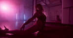 Floor, pole dancer and body of woman with neon light, sexy and split for exotic choreography. Erotic dancing, sensual performance and girl moving to music with flexibility for burlesque show and art
