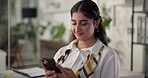 Woman, phone and texting in office with discussion for project management at web design company. Person, smartphone and smile with social media, review and feedback negotiation at creative agency