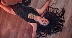 Stripper, dancing and woman on floor with music, burlesque and performance above by pole in club. Erotic dancer, girl or artist moving for sensual art, sexy and face with exotic body in lingerie
