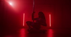 Exotic, dancer and performance in club, pole and dancing with balance for show, talent and artist. Night, silhouette and person with elegance for event, flexible and performer with outfit for routine