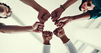 Business, people and hands with fist bump in circle for team building, company solidarity or office community. Low angle, group and closeup together for staff support, synergy or employee integration