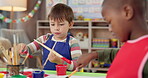 Boy, students and painting art in classroom with creative lesson, drawing picture and kindergarten learning. Kids, artist and canvas with fun activity, artwork project and motor growth for education