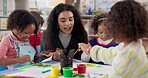 Painting, teacher and talking to children, art and creativity in classroom, growth and development. Happy, woman and teaching kids in preschool, learning or education for youth with color for artwork