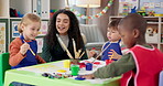 Painting, woman and children in classroom, talking and creative in daycare, growth and development. Art, teacher and teaching kids in preschool, learning or education for youth with color for artwork