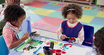 Girl, students and painting hands in classroom for creative lesson, drawing picture and kindergarten learning. Kids, artist and messy with fun activity, artwork project and motor growth for education