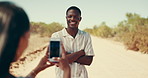 Phone, photograph and travel with couple in desert together for honeymoon, road trip or vacation. Arms crossed, profile picture and social media with people outdoor for bonding, journey or holiday