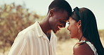 Love, forehead touch and couple in countryside for holiday, vacation and weekend getaway in summer. Interracial, dating and people in nature for travel, bonding and adventure on road trip outdoors