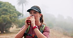 Hiking, woman and drinking coffee in nature on adventure, thinking and relax with fog. Trekking, flask and person outdoor with hot beverage, tea and travel with reflection on vacation in forest