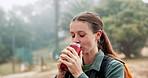Hiking, woman and drinking coffee outdoor on vacation, thinking and relax with fog in winter. Trekking, flask and happy person in nature with hot beverage, tea and travel with reflection in forest