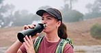 Trekking, woman and drinking coffee in forest on vacation, thinking and relax with fog. Hiking, flask and happy person in nature with hot beverage, tea and travel with reflection or vision outdoor