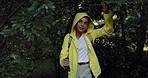 Nature, hiking and woman with stick, raincoat and outdoor adventure holiday on winter weekend. Walking, hill and girl in woods with morning trekking in trees, travel vacation and explore in forest