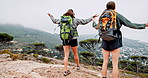 High five, hiking and women on mountain together with success, freedom or achievement on adventure holiday. Celebration, excited and friends on cliff with trekking, travel vacation or jump in nature