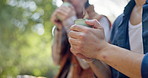 Hands, hiking and couple in forest with coffee, smile or bonding on outdoor adventure holiday together. Warm, drink or people in woods for rest on morning trekking, travel vacation or happy in nature