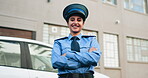 Arms crossed, face and police with woman outdoor in city for patrol or security. Confident, crime and safety with happy officer person downtown in guard uniform for protection or trust as cop