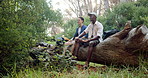 Hiking, friends and men in nature with drink for bonding, relax and conversation outdoors on weekend. Travel, happy and people eating in forest for adventure, journey and exercise on mountain
