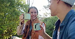 Cheers, hiking and couple in forest with coffee, smile or bonding on outdoor adventure holiday together. Drink, man and woman in woods for rest on morning trekking, travel vacation or happy in nature
