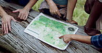 Hands, people or map in woods for hiking, travel planning or pointing in direction. Friends, trekking break or chart on tree for navigation, above or search for location to explore forest with guide
