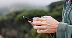 Hiker, hands or person with phone in forest for direction, navigation or location online. Nature, hiking or texting with mobile closeup in woods for signal on outdoor adventure, journey or travel