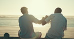 Friends, relax and men fist pump by beach for bonding, conversation and communication. Sunset, nature and back of people for hangout, chill and chatting on holiday, vacation and weekend outdoors