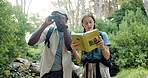 People, friends and book with binoculars in nature for bird watching, adventure or sightseeing in forest. Man, woman or explorers with textbook for journey, information or outdoor expedition in woods