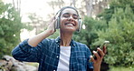 Woman, phone and dancing with headphones in park, nature and trees with audio streaming on web. Girl, person and happy with smartphone, sound and listening to music with mobile app in Costa Rica