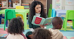 Woman, teacher and reading book with kids in nursery for story time, education or learning. Female person, educator or instructor with elementary children or novel for listening activity in class