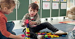 Kids, student and play with blocks in class for learning, problem solving and creative activity. Children, toys and building stack for education game, puzzle solution and motor growth in kindergarden