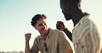 Friends, fist pump and men talking by beach for bonding, conversation and communication. Happy, nature and people relax for hangout, chill and chatting on holiday, vacation and weekend outdoors