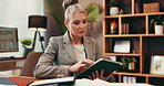 Home office, mature and business woman on tablet for planning law case, research or remote work. Digital technology, communication and scroll with freelance attorney with legal evidence for trial