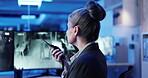 Back, woman and radio in control room for protection, security service and communication at night. Late, mature guard and tech in office for surveillance, contact and building safety update with CCTV