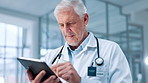Doctor, medical and tablet with man in hospital for review of information or records. Healthcare, stethoscope and telehealth with mature medicine professional in clinic for cardiology results