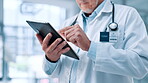 Hands, healthcare and tablet with doctor in hospital for review of information or records. Medical, stethoscope and telehealth with medicine professional man in clinic for cardiology results