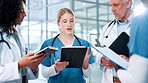 Surgeon, group or doctors in hospital with tablet for planning, health treatment results or meeting. Clipboard, teamwork or people in discussion for medical advice, schedule or diagnosis research