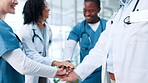 Hands together, doctors and team support, applause and celebration for surgery mission in hospital lobby. Medical professional group, clapping and people with success or motivation for healthcare