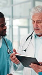 People, doctor and check tablet at hospital with planning, feedback and medical results of surgery. Mature mentor, talk and digital with staff update, healthcare report and brainstorming for solution