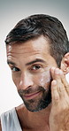 Mature man, face or skincare with moisturizer in studio for facial treatment on a white background. Portrait, male person or model applying cosmetics with cream, lotion or protection for smooth skin