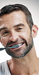Mature man, face and cleaning teeth with toothbrush in studio for dental care on a white background. Portrait, male person or model brushing with smile or tool for oral hygiene, fresh breath or gums