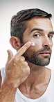 Mature man, skincare and face cream with moisturizer in studio for facial treatment on a white background. Portrait, male person or model with smile, cosmetics or creme for lotion or skin protection