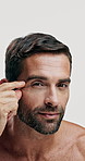 Beauty, face and wrinkles with man in studio for dermatology, anti aging and self care. Crows feet treatment, cosmetics and inspection with mature person on white background for grooming and facial