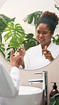 Happy, black woman and bathroom with confidence in mirror for self love, skincare or routine at home. Female person, talking and reflection with conversation or chat for vibe, feeling good or hygiene