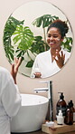 Beauty, cream and mirror with woman in bathroom for self care, glow and facial treatment. Cosmetics, grooming and vitamin c lotion with person at home for dermatology, skincare and reflection